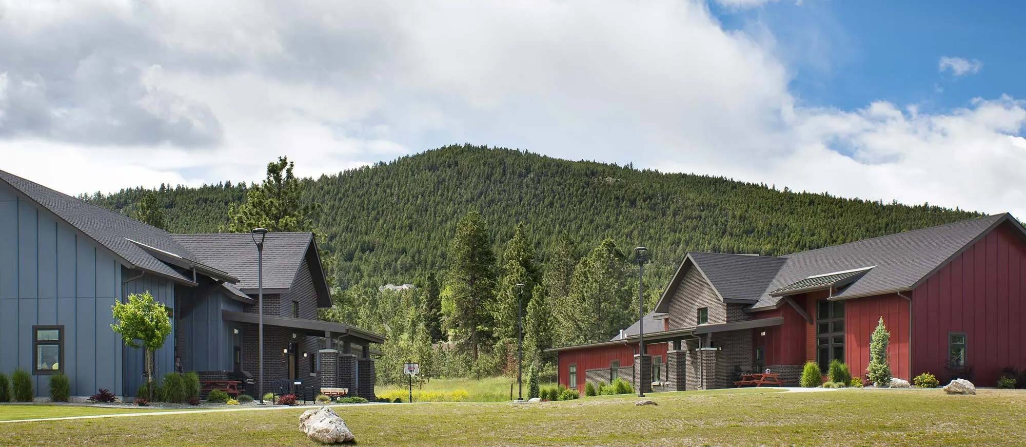 View of mountains with two residential buildings in the foreground