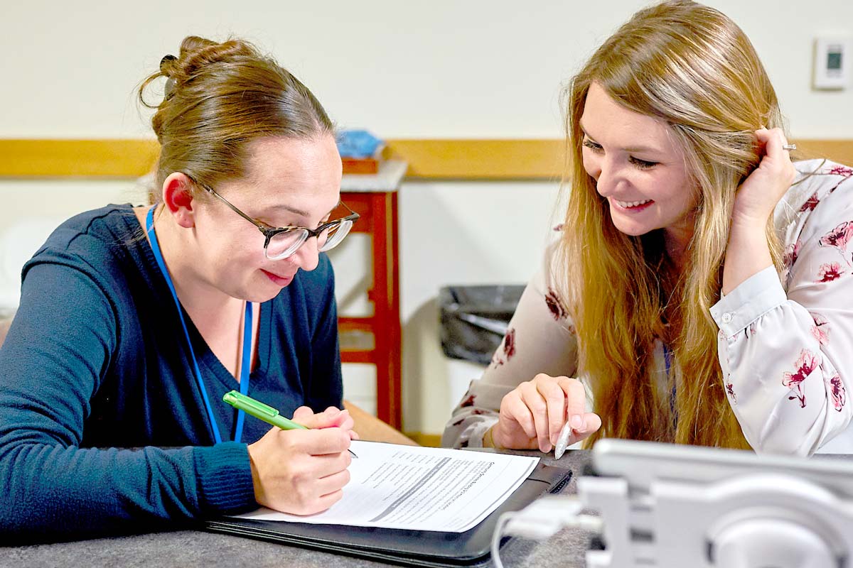 Two women reviewing paperwork
