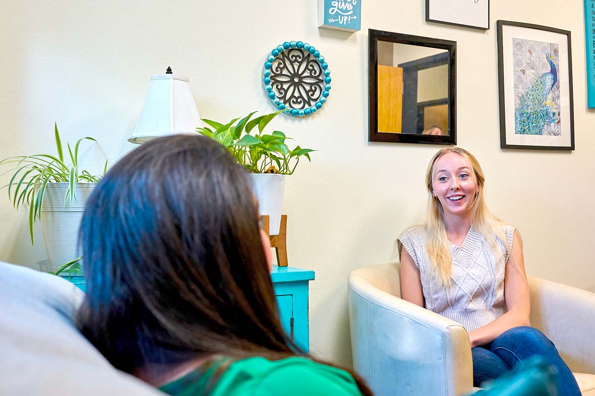 Two women talking in an office setting