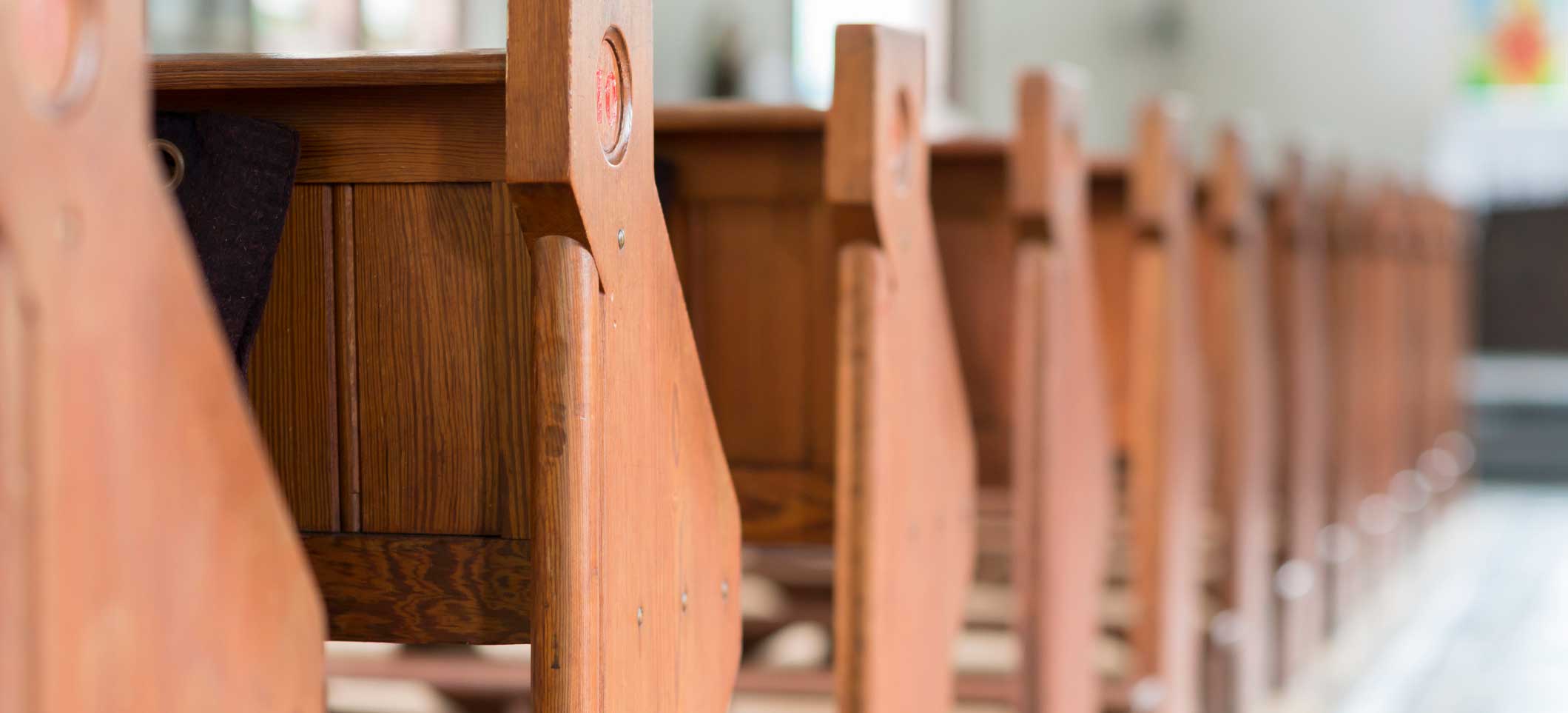 Closeup of a row of church pews