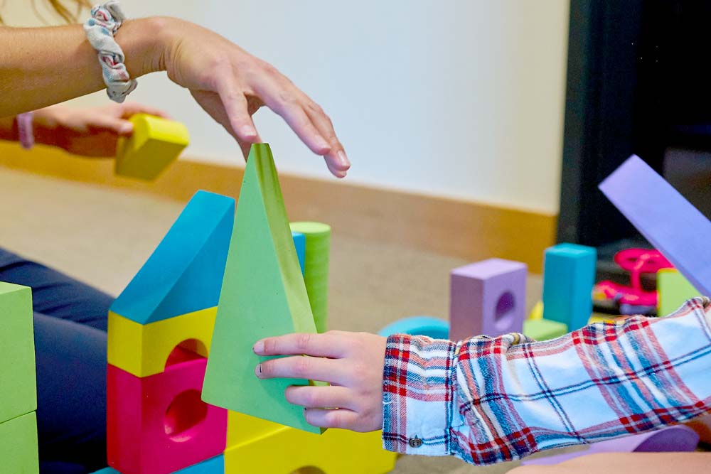 Child's hand holding a block