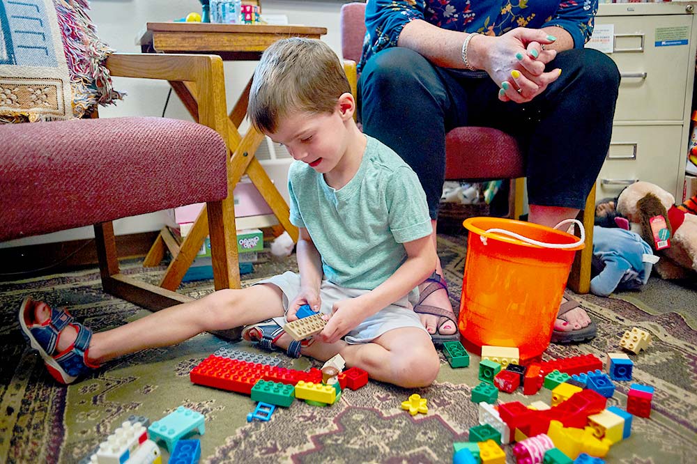 Boy smiling and playing with blocks
